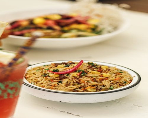 Bowl with rice, beans and mixed cooked vegetables